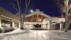 a building in the snow at night at The Green Leaf, Niseko Village in Niseko