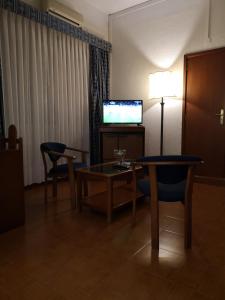 a living room with a table and a television at Hotel Nazareth in Lisbon +17 photos