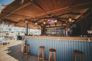 a bar with wooden stools at a bar with a counter at Трехкомнатные апартаменты в жилом комплексе Caesar Beach D2 Flat4 in Boğaz