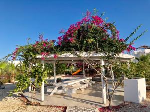 a picnic shelter with flowers on top of it at Трехкомнатные апартаменты в жилом комплексе Caesar Beach D2 Flat4 in Boğaz