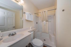 a bathroom with a sink and a toilet and a mirror at Tampa Bay Extended Stay Hotel in Largo +42 photos