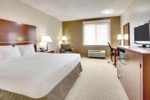 a hotel room with a large bed and a flat screen tv at Hollywood Casino Joliet Hotel in Joliet