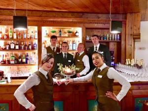 a group of people standing at a bar at Parkhotel Ladinia in San Vito di Cadore +80 photos
