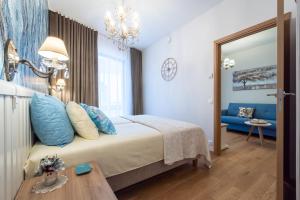 a bedroom with a large bed with blue pillows at Rotermann Square view Apartment in Tallinn