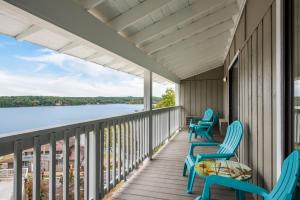 a balcony with chairs and a view of the water at Margaritaville Lake Resort Lake of the Ozarks in Osage Beach
