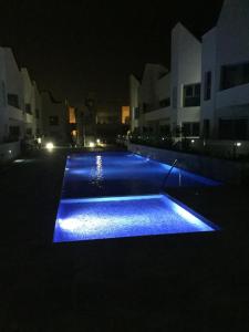 a swimming pool lit up at night with blue lights at Villa Amalia 54 in Torrevieja