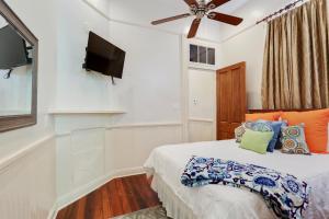 a bedroom with a bed and a flat screen tv at Iberville Quarters in New Orleans