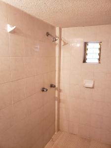 a bathroom with a shower with a window at Hotel Anturio in Huajuapan de León