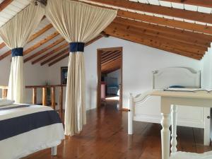 a bedroom with a bed and a wooden floor at Casa do Mar in Ribeira Seca do Porto