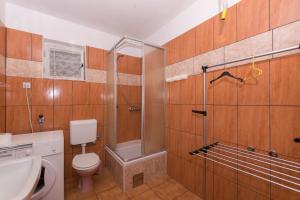 a bathroom with a shower and a toilet and a sink at Apartments Amalija in Vodice