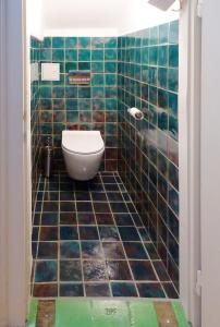 a bathroom with a toilet and a tiled floor at Apartment Center in Gmunden