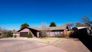 a home with a pink house with a driveway at Hoodoo House - 4-Bedroom Near Lake Powell in Page