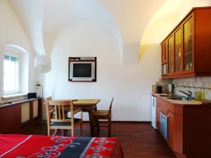 a kitchen and dining room with a table in a room at Gewölbezimmer am Marktplatz in Gmunden