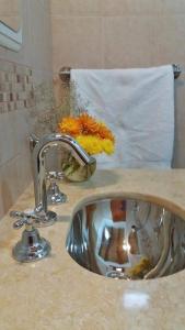 a bathroom counter with a sink and a mirror at La Cabañita de Tilcara in Tilcara