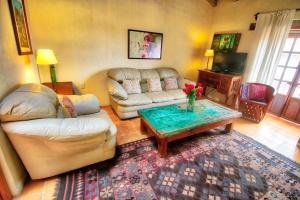 a living room with a couch and a coffee table at Hotel Casa Encantada in Pátzcuaro
