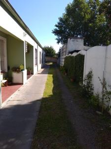 una acera junto a una casa con una valla en Venezuela en Tandil