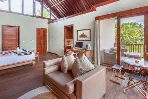 a living room with a couch and a bedroom at Solo Villas & Retreat in Ubud +49 photos