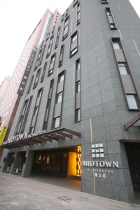 a large building with a sign on the front of it at Hotel Midtown Richardson - Kaohsiung Bo'ai in Kaohsiung