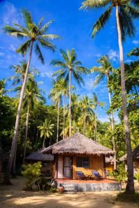 a small house with palm trees in front of it at Mayalay Resort-Green Hotel in Ko Ngai