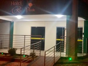 a building with two entrances with green lights at Hotel Rio Verde in Dianópolis