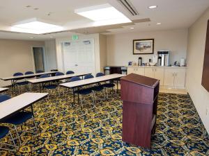 a classroom with tables and chairs and a counter at SureStay Plus Hotel by Best Western Billings in Billings