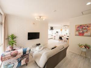 a living room with a couch and a table at Villa Suite HANA 2Bed room まるまる1棟貸切#北部観光に最適な立地 in Nago