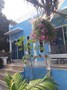 a blue house with flowers on the side of it at Belinda Home in Ko Si Chang