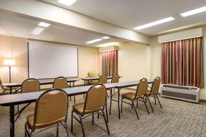 a conference room with tables and chairs and a whiteboard at Quality Inn Thomaston in Thomaston
