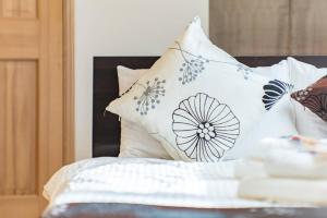 a bed with pillows on top of it at Villa Kamakura in Kamakura +40 photos