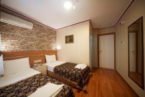 Postel nebo postele na pokoji v ubytování Hotel Akcinar