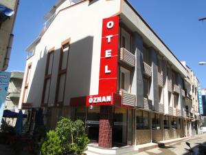 a building with a red sign on the side of it at Özhan Hotel in Antalya