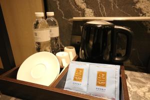 a counter with a jar of soap and a bottle of water at Hotel Midtown Richardson - Kaohsiung Bo'ai in Kaohsiung