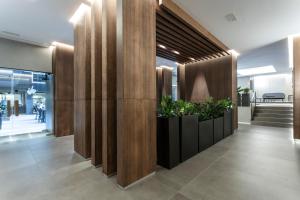 a lobby with wooden walls and potted plants at Les Closes in Andorra la Vella