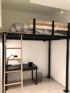 a bunk bed with a desk in a room at California in Nice