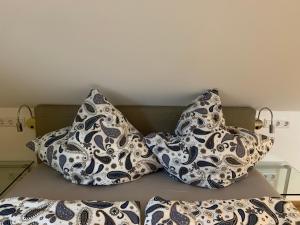 two pillows sitting on top of a bed at Apartment Köln Ensen in Cologne