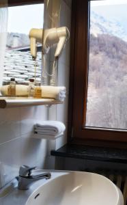 a bathroom with a sink and a window at Hotel Etoile De Neige in Valtournenche
