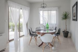 a dining room with a table and chairs at Villa 26 in Paphos