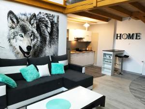 a living room with a wolf painting on the wall at Apartamenty Centrum Rajcza in Rajcza