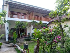 ein Haus mit Balkon und einigen Pflanzen in der Unterkunft Dili Gili in Gili Trawangan