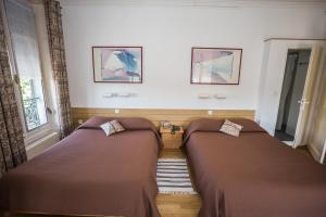 Cama o camas de una habitación en Hotel des Tourelles