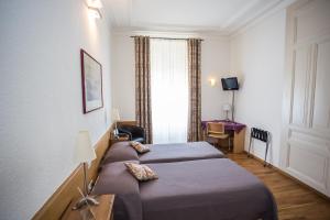 Cama o camas de una habitación en Hotel des Tourelles