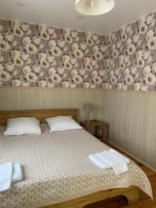 a bedroom with a bed with two towels on it at Usadba Demidova in Listvyanka