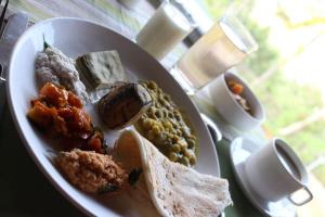a plate of food with different types of food on a table at Mary Land Homestay in Trivandrum