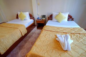 Postel nebo postele na pokoji v ubytování Royal Hotel