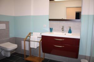 a bathroom with a sink and a toilet at Apartment St. Pölten in Sankt Pölten