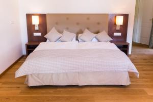 a bedroom with a large bed with two night stands at Stiftsschmiede Ossiach in Ossiach