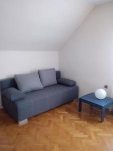 a living room with a blue couch and a table at villa in Nowa Ruda