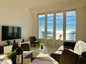 a living room with a bottle of wine on a table at Florida Blue - Easy Home Booking in Nice