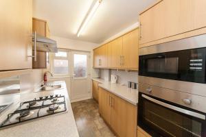 a kitchen with a sink and a stove top oven at Belmont Budget Apartment in Stockton-on-Tees