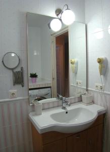 a bathroom with a sink and a large mirror at Your Vacation Retreat Right On The Beach in Casares +68 photos